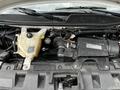 2019 Chevrolet Express engine compartment showing the engine components including coolant reservoir and air intake system