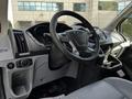 Interior view of a 2015 Ford Transit showing the steering wheel dashboard and central control panel