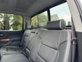Interior of a 2017 Chevrolet Silverado 1500 showing the back seat with black leather upholstery and headrests