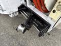 A close-up view of the hitch and towing mechanism on a 2016 Peterbilt 348 truck showing various components including a coupler and hydraulic connections