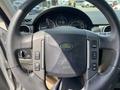 Close-up of the steering wheel of a 2006 Land Rover LR3 featuring controls for audio and cruise settings with the Land Rover logo in the center
