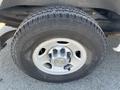 A close-up of a tire from a 2012 Chevrolet Express showing the tread pattern and wheel rim with the Chevrolet logo