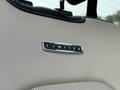 Close-up of a stitched leather seat featuring a chrome badge that reads LIMITED on a 2021 Ford F-350 SD