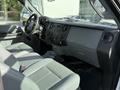 Interior view of a 2011 Ford F-250 SD featuring gray leather seats and a dashboard with audio controls and air vents