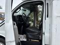 Interior of a 2020 Chevrolet Express showing the driver's seat steering wheel and dashboard with controls