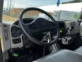 The image shows the interior cabin of a 2019 International 4300 featuring a steering wheel dashboard controls and a touchscreen display