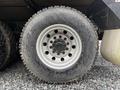 A close-up view of a tire mounted on a wheel belonging to a 2018 Kenworth T800 showing deep treads and visible wear on the rubber surface