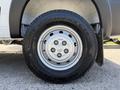 A close-up of a 2021 RAM Promaster wheel showing the silver alloy rim and a sturdy all-season tire with visible tread patterns