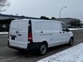 A white 2019 Mercedes-Benz Metris parked on the side of a road with a blank rear door and no visible cargo