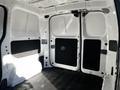 Interior view of a 2017 Nissan NV200 cargo van with empty space and double doors opened at the back