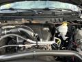 Engine compartment of a 2015 RAM 1500 showing the engine block with various hoses and components including the cooling system reservoir and air intake features