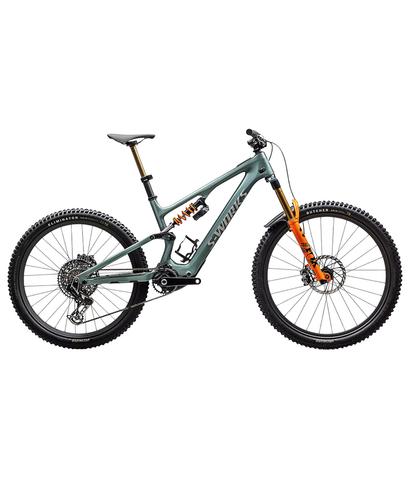 A 2025 Specialized S-Works Turbo Levo SL 2 LTD bike with a green frame and orange accents featuring thick tires and a suspension system designed for off-road cycling