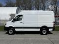 A white 2017 Mercedes-Benz Sprinter van positioned in profile showcasing its streamlined design and high roof