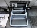 A black plastic cup holder insert designed for a 2010 Ford Ranger featuring two compartments with a flat bottom and textured surface