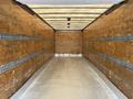 Interior of a 2017 Hino 338 box truck with wooden walls and metal tie rails along the sides for securing cargo