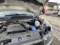 Close-up view of the engine compartment of a 2012 Chevrolet Express showing various engine components and a visible air intake system