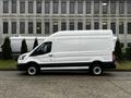 A white 2021 Ford Transit van with a high roof and black trim parked sideways