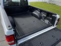 A 2010 Ford Ranger with an empty truck bed featuring a textured rubber liner and a visible Ford logo