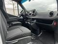 Interior of a 2021 Mercedes-Benz Sprinter featuring a driver's seat dashboard and controls with black upholstery and a vinyl floor mat