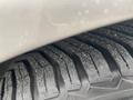 Close-up of the tread pattern on a tire from a 2007 Mercedes-Benz E-Class showing deep grooves and textured rubber