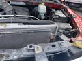 Close-up of the engine compartment of a 2012 RAM 2500 showing the radiator and surrounding components