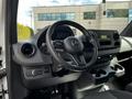 Interior view of a 2020 Mercedes-Benz Sprinter highlighting the steering wheel dashboard and center console with cup holders