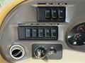 Control panel of a 2000 Ford Motorhome featuring multiple switches for dome light fan and utility lighting along with dials for fan speed and panel dimming