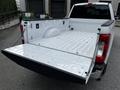 A 2017 Ford F-250 truck with its tailgate down revealing an empty truck bed