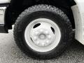 Close-up of a white wheel from a 2013 Ford Econoline featuring a Goodyear tire with deep treads and a multi-bolt pattern on the rim