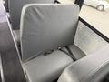 Interior view of a grey seat inside a 2022 Freightliner B2 bus with a seatbelt attached