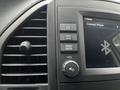 Interior dashboard controls of a 2023 Mercedes-Benz Metris featuring buttons for navigation, map, radio, media, volume, and a Bluetooth indicator
