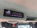 A Pioneer car stereo installed in the cabin of a 2014 Kubota X1100C showing the time 1205 PM with glowing purple accents