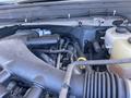 Engine components of a 2015 Ford F-450 SD including air intake tubes hoses and visible fluids