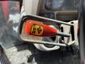 A close-up view of the gear shift lever labeled FNR Lift on a 2011 Kubota M8540D tractor with a red handle and metallic shaft