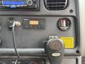 Interior dashboard of a 2014 Freightliner B2 featuring controls gauges and a warning label
