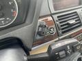 A 2009 BMW X5 ignition switch and key fob are visible inside the vehicle's dashboard near the speedometer and control panel