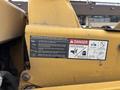 A yellow Vermeer Corporation BC1200XL wood chipper featuring a maintenance checklist and warning labels about safety precautions related to engine operation and moving parts