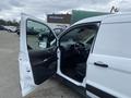A 2017 Ford Transit Connect with its driver side door open showcasing the interior and steering wheel