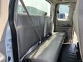Interior view of a 2008 Ford F-450 SD showing the rear bench seat with seatbelts and textured flooring