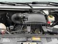 Close-up of the engine compartment of a 2017 Mercedes-Benz Sprinter showing the air filter and various engine components