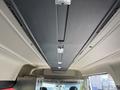 Interior view of a 2021 RAM Promaster showing the ceiling with overhead storage compartments and built-in lighting