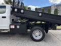A 2017 Ford F-550 with a raised dump bed and a spill kit mounted on the side