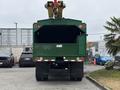 A green 2015 Freightliner M2 106 truck viewed from the rear with a large open cargo bay and a crane attachment visible on top