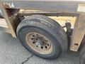 A close-up of a worn tire on a 2013 JLG Industries 1014 with visible rust and dirt on the wheel rim