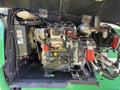 Engine compartment of a 2015 JLG 450AJ featuring various mechanical components including hoses and fuel filters