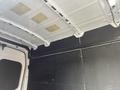 Interior view of a 2023 Ford Transit showing the vehicle's ceiling and walls with a black panel and exposed metal framework