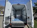A 2016 Mercedes-Benz Sprinter cargo van with open rear doors displaying a spacious interior featuring metal flooring and walls