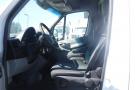 Interior view of a 2012 Mercedes-Benz Sprinter showing the driver's seat and dashboard with steering wheel and controls visible