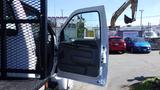 A 2006 Ford F-650 with an open door displaying the interior features and control panel