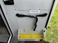 A 2013 Chevrolet Express door with a storage area featuring a strap and a yellow textured mat for securing items